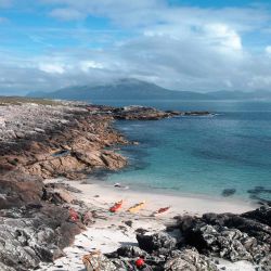 kayaks on a rugged island beach