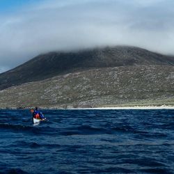 sea kayaker and the mountains of Harris