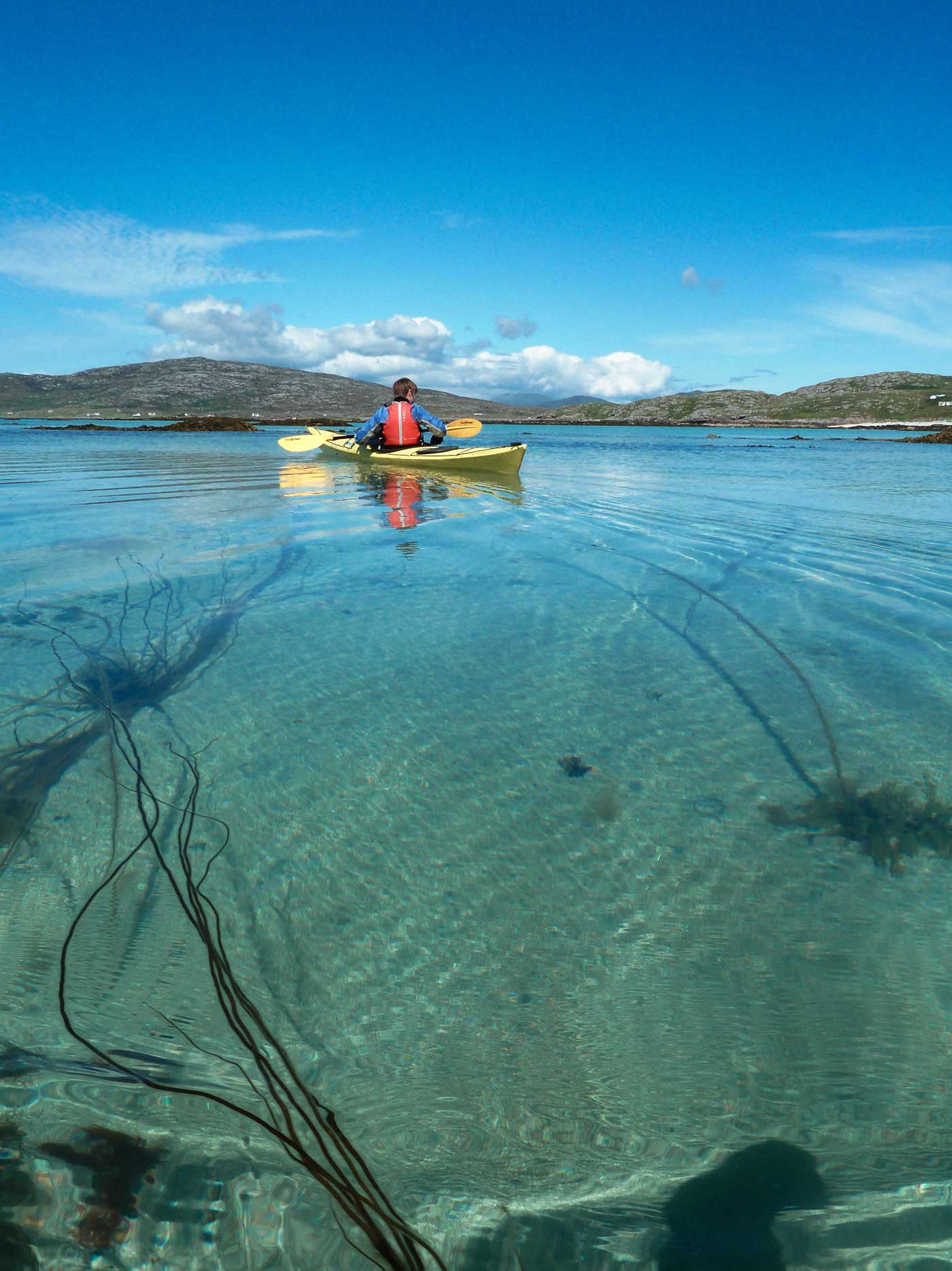 kayaker on crystal clear sea