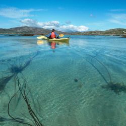 kayaker on crystal clear sea